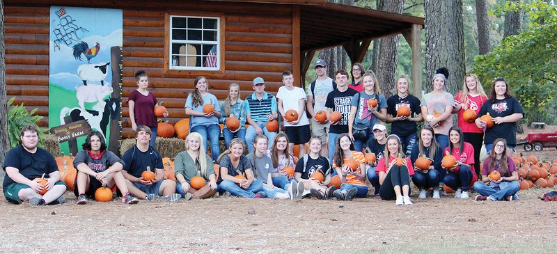 Haskell Harmony Grove High School seniors visited the Family Farm Christian Day Camp in Malvern on Monday to pick out pumpkins with their former kindergarten teacher, Pam Henley, who plans to retire this academic year. The students missed out on the school’s traditional pumpkin patch trip when they were in Henley’s kindergarten class 12 years ago because of a tornado that hit their school. In the front row, from left, are Devlyn Smith, Ryan Richmond, Chris Knight, Angie Phillips, Bailey Hennigan, Cassidy Hopkins, Kayla Combs, Abby Jo Windsor, Morgan Gober, Madison Mickle, Natalie Jones, Kassadie Havinear, Lexi Montalvo and Allie Woodville; and in the back row are Breanna Eubanks, Kaylee Breckling, Kaleigh Lewis, Kyler Kindy, Caleb Pittman, Blake Doddridge, Michael Hackler, Triston Abbott, Jasmine Allred, Jessica Allred, Morgan George, Bailey Wallis and Emily Kosters.