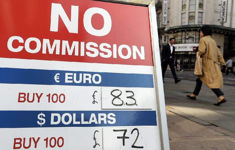 A sign at a currency bureau in London displays the pound’s exchange rate on Tuesday.
