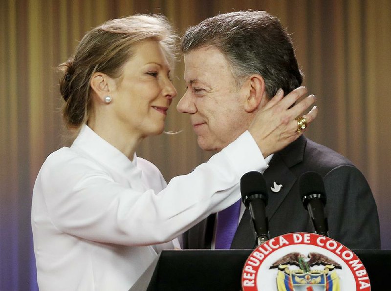 Colombian President Juan Manuel Santos is embraced by his wife, Maria Clemencia Rodriguez, after an appearance Friday at the presidential palace in Bogota to discuss his Nobel Peace Prize. 