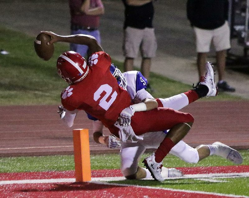 Cabot quarterback Jarrod Barnes stretches toward the end zone as he is tackled by Conway’s Will Kennedy during the first quarter of Friday night’s game in Cabot. Barnes was ruled to be stopped shy of the goal line, but he scored on a 1-yard run on the next play as the Panthers took a 14-0 lead. However, Conway scored 37 consecutive points and won 37-14.