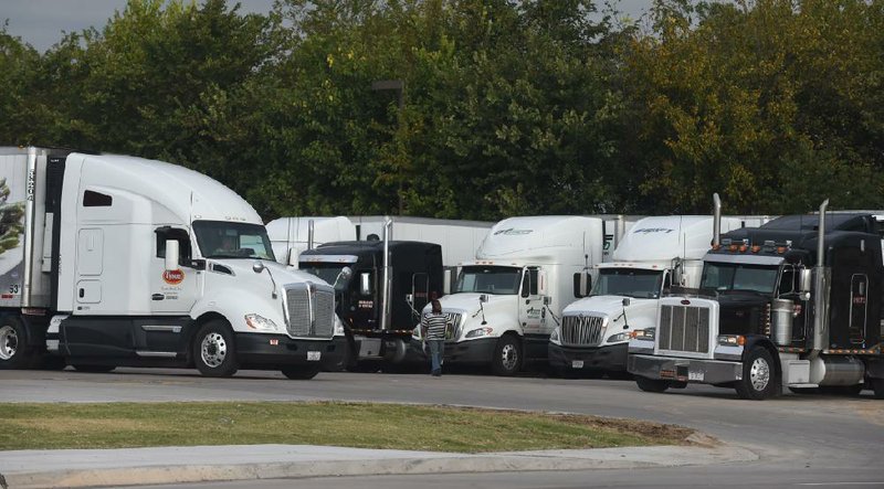 Truck drivers look for a place to park in the back of the Pilot Truck Stop in Springdale. Many drivers have a hard time fi nding a place to park their rigs and rest.