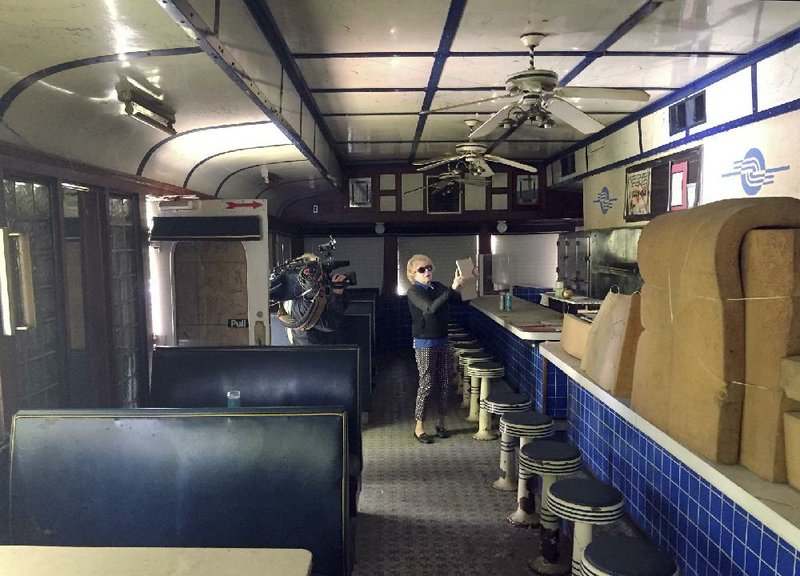 Bridget Trepsas, of Salem, N.H., takes a photograph inside the Silver Top Diner on Wednesday, in Pawtucket, R.I., while attending its auction with her daughter Marybeth Shanahan, who owns the Dream Diner, in Tyngsborough, Mass.
