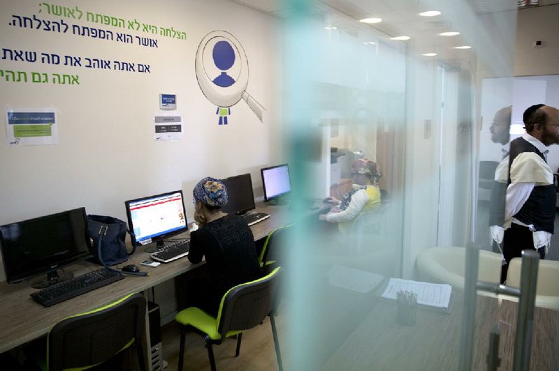 An ultra-Orthodox Jewish woman sits in an employment training center in the city of Elad in central Israel. Younger ultra-Orthodox Jews are challenging tradition by entering the workforce and seeking higher education.