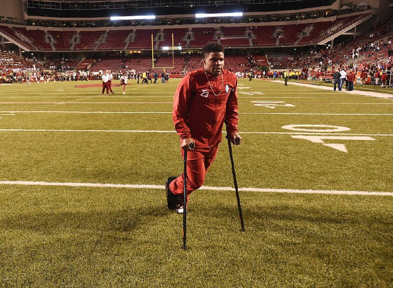 Arkansas linebacker Dre Greenlaw suffered a broken right foot Saturday and will have surgery Monday.