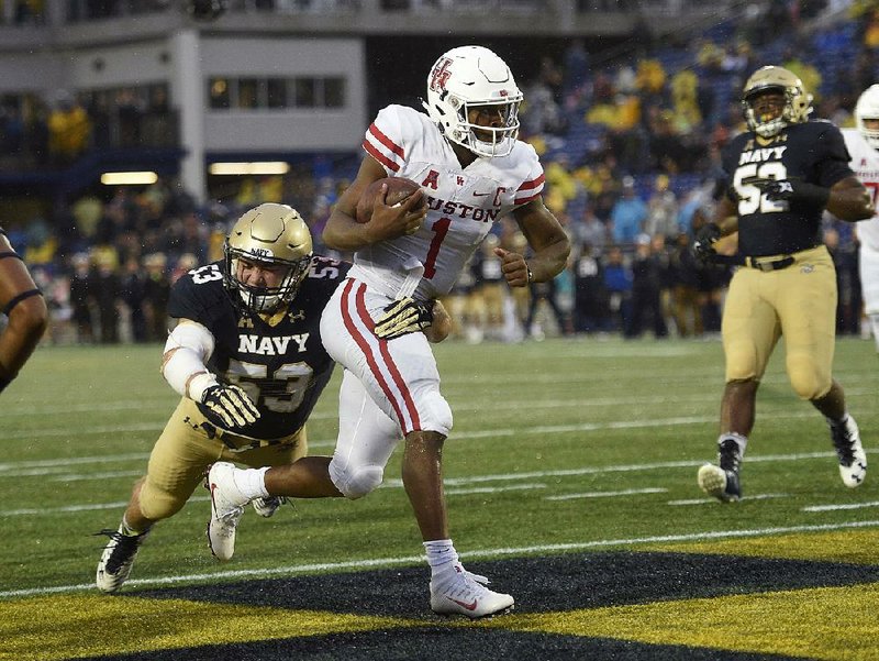 Houston quarterback Greg Ward Jr. (1) ran for 94 yards and a touchdown and threw for 359 yards with 3 more touchdowns, but the No. 6 Cougars fell to Navy 46-40 on Saturday in Annapolis, Md.