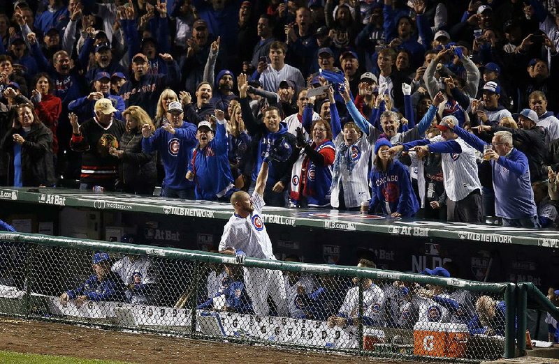 Travis Wood (Bryant) receives a curtain call after hitting a home run in the fourth inning of the Cubs 5-2 victory over San Francisco Giants in Game 2 of the National League division series. Wood also pitched 11/3 perfect innings to get the victory in relief of Kyle Hendricks, who left after taking a line drive off his forearm.