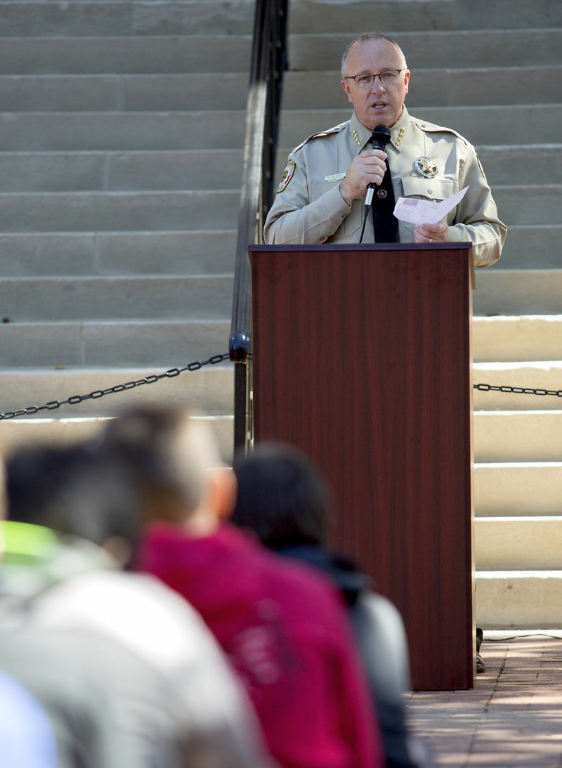 Benton County Sheriff Meyer Gilbert reads a pledge Sept. 30 declaring October as Substance Abuse Awareness Month in Benton County at the courthouse in Bentonville.