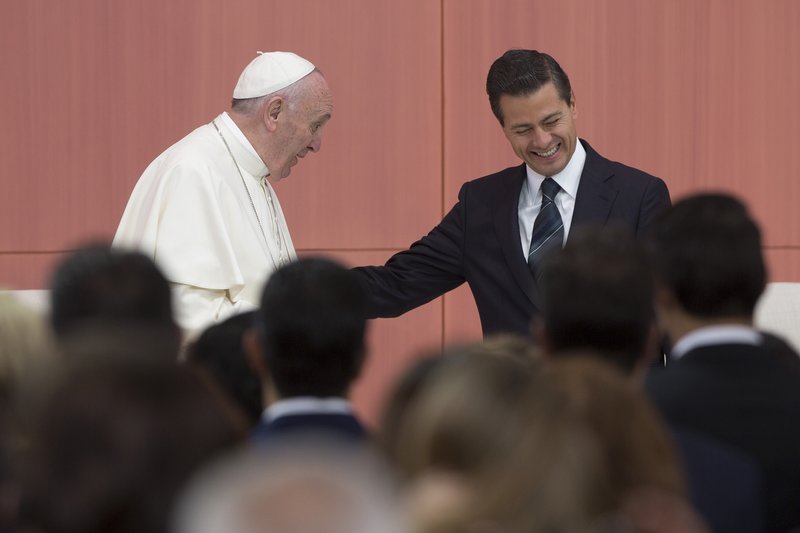 Pope Francis (left) speaks as Mexican President Enrique Pena Nieto reacts during the welcoming ceremony at The National Palace in Mexico City, Mexico on Feb. 13, 2016. 