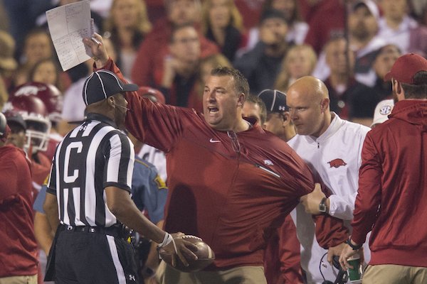 Arkansas coach Bret Bielema is restrained while talking to an official during Arkansas' loss to No. 1 Alabama.