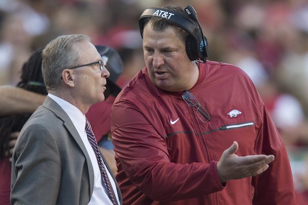 Arkansas football coach Bret Bielema talks with athletic director Jeff Long during Arkansas' game against No. 1 Alabama on Saturday, Oct. 8, 2016.