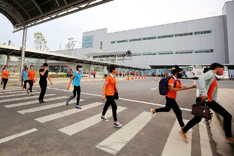 Workers leave a Samsung Electronics Vietnam Co. plant after finishing their shift at Yen Phong Industrial Park in Bac Ninh Province, Vietnam, last month.