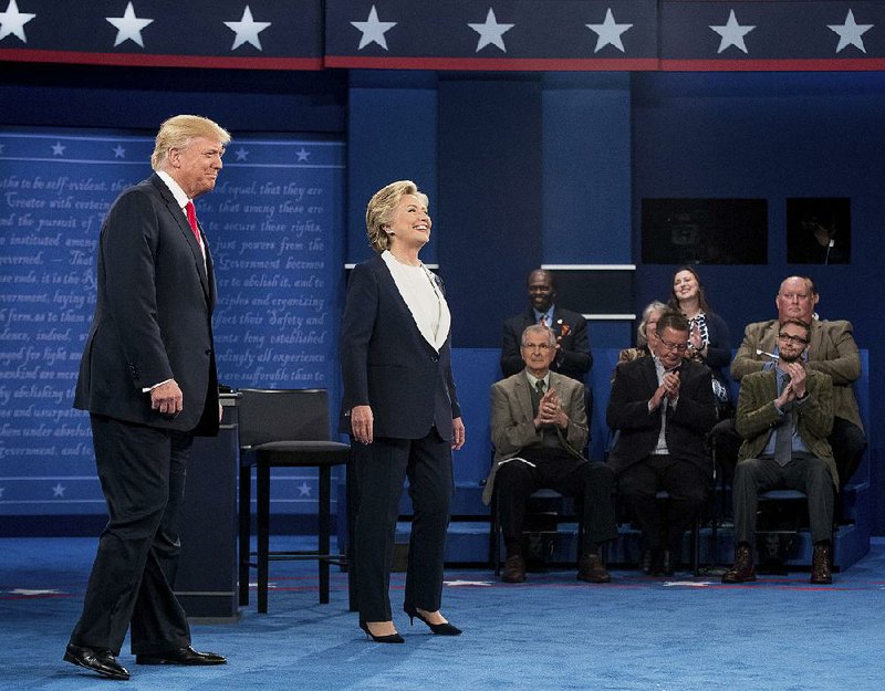 Democratic presidential candidate Hillary Clinton stands next to Republican presidential candidate Donald Trump at the second presidential debate at Washington University, Sunday, Oct. 9, 2016, in St. Louis.