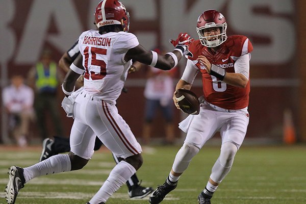 Arkansas quarterback Austin Allen scrambles while being pressured by Alabama defensive back Ronnie Harrison during a game Oct. 8, 2016, in Fayetteville. 