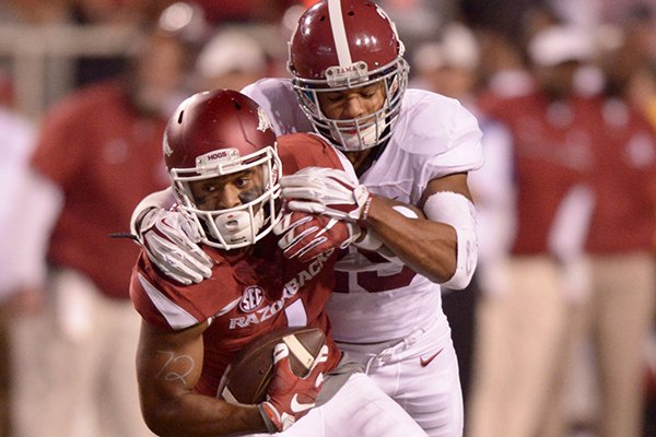 Arkansas receiver Jared Cornelius is tackled by Alabama defensive back Minkah Fitzpatrick during a game Saturday, Oct. 8, 2016, in Fayetteville. 