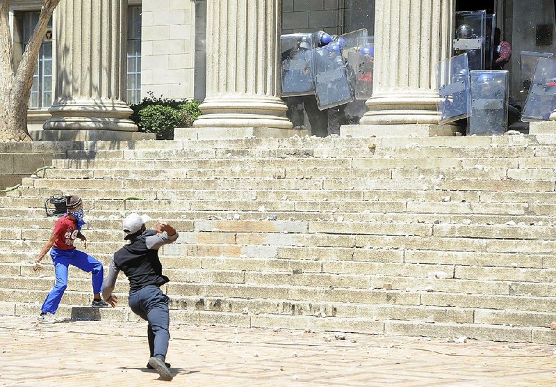 Students hurl stones on the University of the Witwatersrand campus in Johannesburg, South Africa, on Monday.