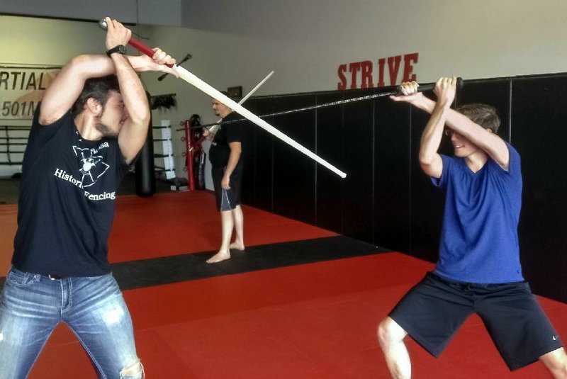 Sword-fighting enthusiasts include Dylan Clarke (left) and Max Kelsey of the Central Arkansas Historical Fencing club.