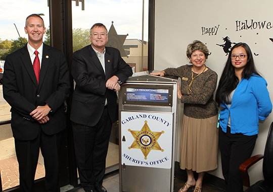 The Sentinel-Record/Richard Rasmussen PARTNERSHIP FOR SUCCESS: Ouachita Children's Center debuted a new prescription drug drop box Monday in the lobby of the Garland County Sheriff's Department. From left are Chief Deputy Jason Lawrence, Sheriff Mike McCormick, OCC Executive Director Linda Ragsdale and Susie Reece, Partnership for Success coordinator. The drop box can be accessed weekdays from 8 a.m. to 5 p.m.