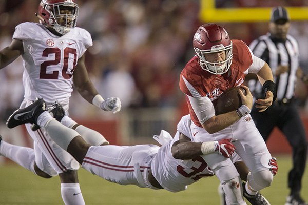 Arkansas quarterback Austin Allen is tackled by Alabama defenders during a game Saturday, Oct. 8, 2016, in Fayetteville. 