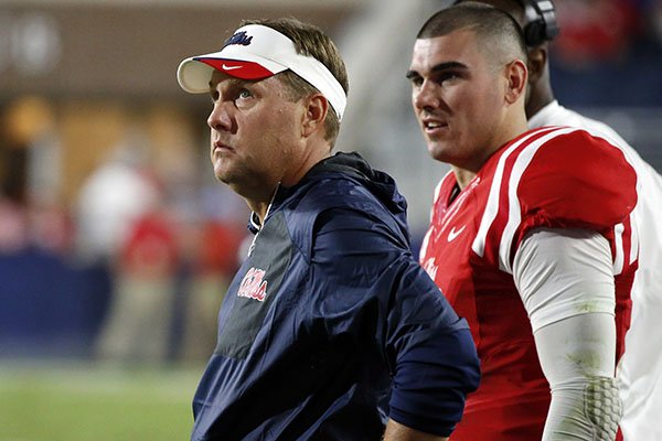 Mississippi head coach Hugh Freeze and starting quarterback Chad Kelly (10) watch the final seconds wind down on the score board at the end of their NCAA college football game against Memphis, Saturday, Oct. 1, 2016, in Oxford, Miss. Mississippi won 48-28. (AP Photo/Rogelio V. Solis)

