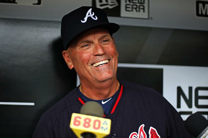 In this May 17, 2016, file photo, Atlanta Braves interim manager Brian Snitker talks with reporters in the dugout before the team's baseball game against the Pittsburgh Pirates in Pittsburgh. The Braves have named Snitker as manager, Tuesday, Oct. 11, 2016, rewarding him for reversing the team’s direction in his role as interim manager this season.  