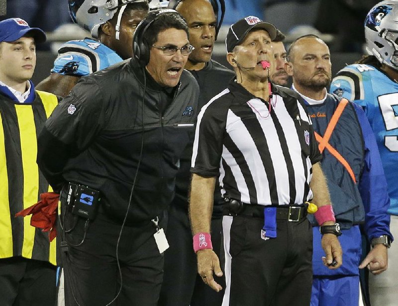 Carolina Panthers Coach Ron Rivera (left) has a few things to say to an official as the Panthers lost 17-14 to the Tampa Bay Buccaneers on Monday night to fall to 1-4. 