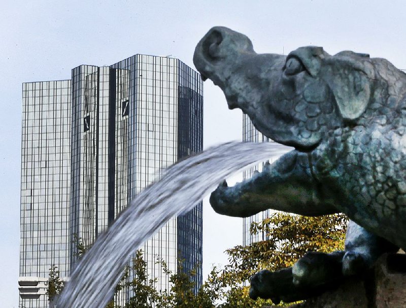 Water spills from a dragon sculpture near the Deutsche Bank headquarters in Frankfurt, Germany, on Tuesday. The U.S. is looking to collect on multibillion dollar penalties from the bank, Germany’s biggest, and from Volkswagen, its biggest carmaker. 