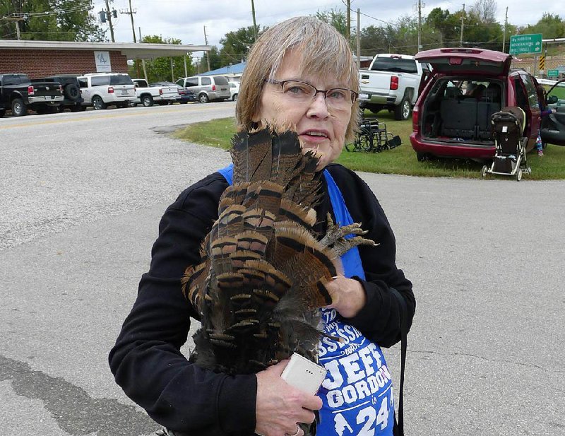 Barb Klug of Bull Shoals got one of the turkeys that was dropped from an airplane Friday at the Yellville Turkey Trot festival. The bird died from the fall. 