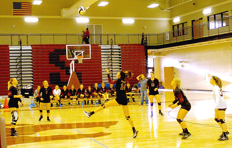 MARK HUMPHREY ENTERPRISE-LEADER Lincoln junior Madison Jones gets a play on the volleyball while her teammates look to set up their offense against Gravette Sept. 22. The Lady Wolves were defeated, 25-22, 25-10, 25-13.