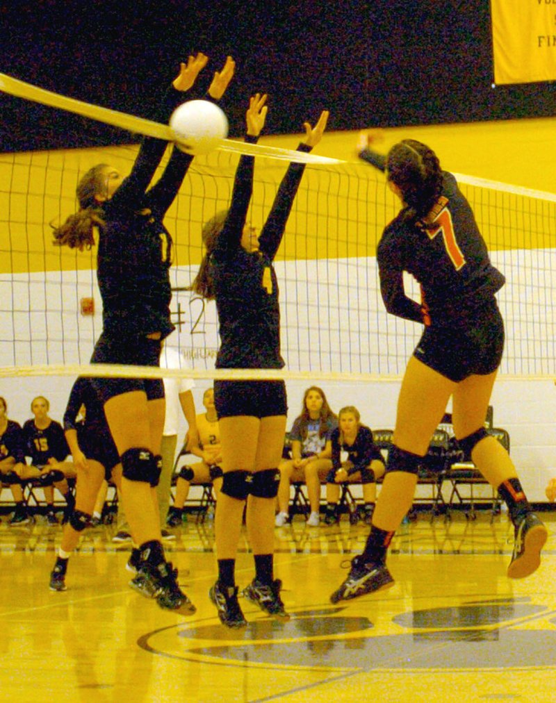 MARK HUMPHREY ENTERPRISE-LEADER Prairie Grove senior Riley Gerwig and sophomore Kayley Anderson team up for a block against Gravette. The Lady Tigers fell behind before winning a home volleyball match (24-26, 13-25, 25-23, 25-18, 15-9) against Gravette Sept. 27.