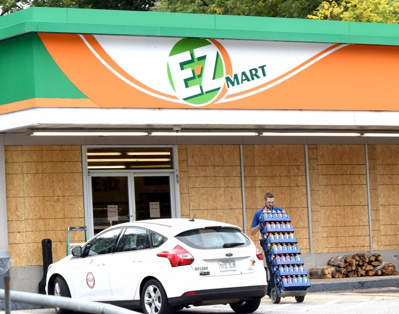 Photo by Mike Eckels A vendor pulls cases of soda pop out of the EZ Mart in Decatur after the store permanently closed at 6 a.m. Oct. 5.