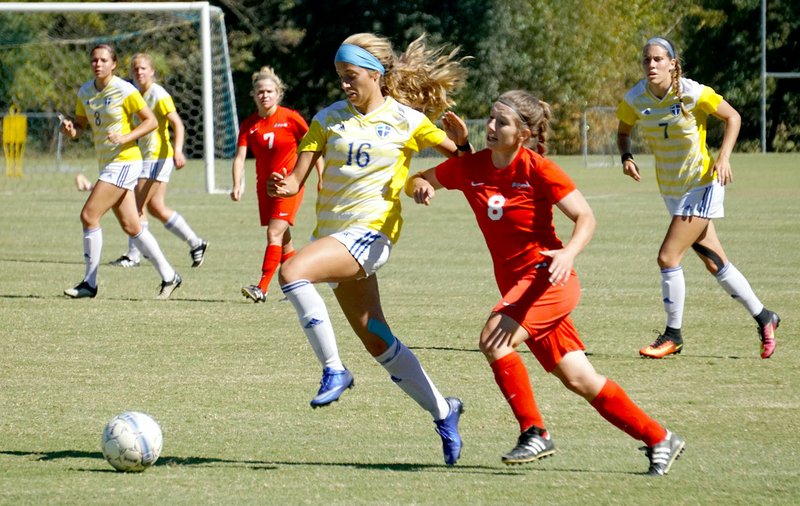 Photo courtesy of JBU Sports Information John Brown University freshman Kristen Howell outruns a St. Gregory&#8217;s (Okla.) defender on her way to scoring one of her four goals Saturday in JBU&#8217;s 9-0 win.