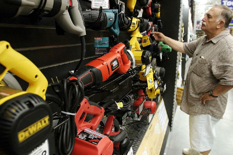 A shopper checks out Black & Decker Corp. power-tools at a Lowe’s Home Improvement Center in Brooklyn, N.Y., in this file photo. 