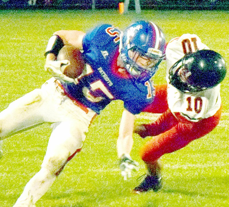 PHOTO BY RICK PECK McDonald County&#8217;s Jack Bowers brings down East Newton&#8217;s Brett Pendergraft during the Patriots 56-34 win Friday night at East Newton High School.