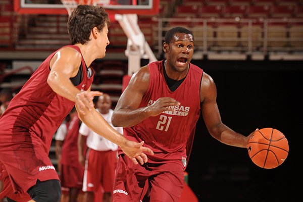 Arkansas' Manuale Watkins (right) drives around Dusty Hannahs during practice Wednesday, Oct. 5, 2016, in Bud Walton Arena.