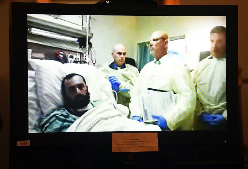 Ahmad Khan Rahimi appears on video from his hospital bed in Newark, N.J., for a hearing Thursday in Elizabeth, N.J. 