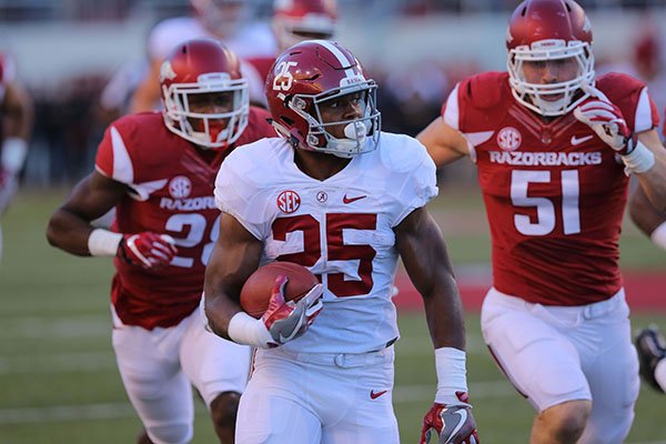 Alabama running back Joshua Jacobs is pursued by Arkansas defenders during a game Saturday, Oct. 8, 2016, in Fayetteville. 