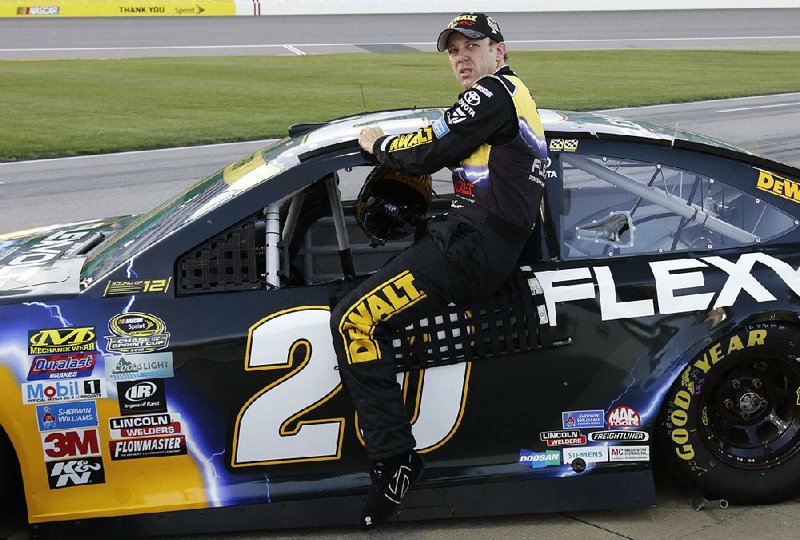 NASCAR Sprint Cup driver Matt Kenseth climbs out of his car after qualifying at Kansas Speedway in Kansas City, Kan., on Friday. Kenseth, who won the pole for Sunday’s race, was followed by Kyle Busch in second and Carl Edwards in third. All three drive for Joe Gibbs Racing.