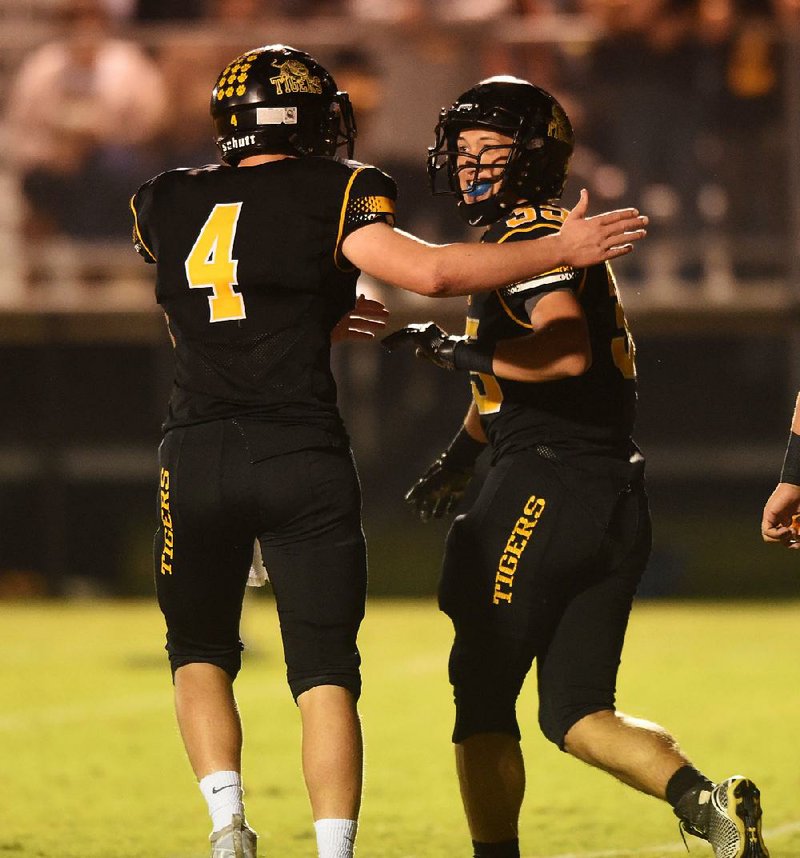 Prairie Grove running back Kyle Sam (35) celebrates with quarterback Zeke Laird (4) after scoring a touchdown during Friday’s game against Pea Ridge in Prairie Grove.