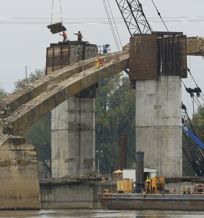 Workers continue preparations Friday for the demolition of the Broadway Bridge’s concrete arches. The demolition was scheduled for Friday afternoon but was postponed because of weather concerns.