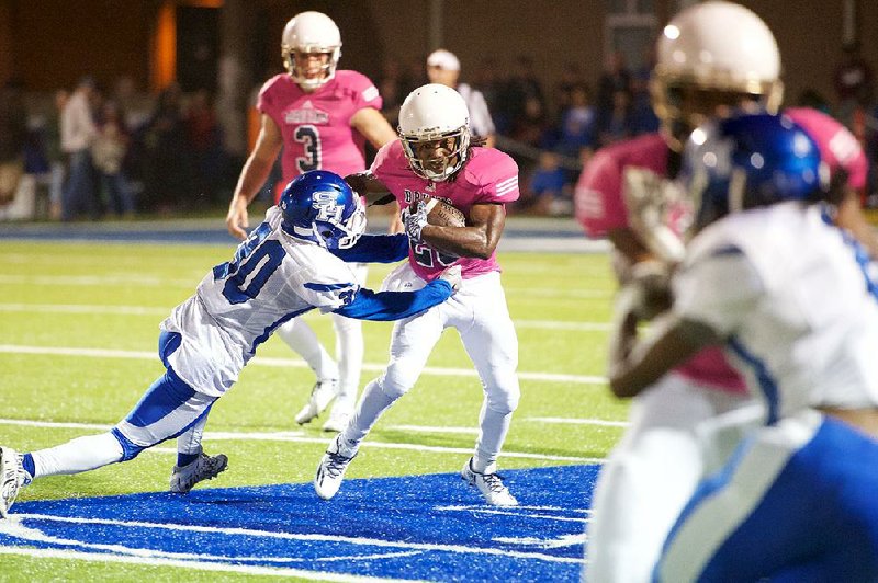 Pulaski Academy running back Jaren Watkins (right) cannot avoid Sylvan Hills linebacker Davien Farr during Friday night’s game.