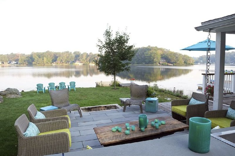 This summer entertaining space can easily be used during colder fall weather with the help of a large fire pit. The designer, Kristina Crestin, strategically placed the fire pit so that some guests could enjoy it relaxing in chairs while others could cluster around it while standing on the lawn. 