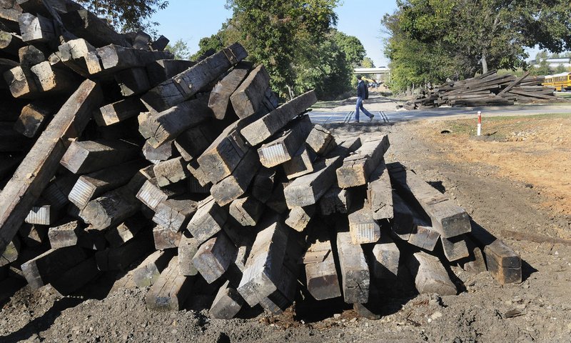 Railroad ties are piled up Tuesday at Northwest Arkansas Community College in Bentonville where tracks were removed.