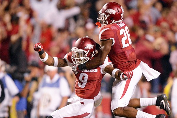 Arkansas safeties Santos Ramirez (9) and Josh Liddell (28) celebrate following the Razorbacks' final defensive play during a game against Ole Miss on Saturday, Oct. 15, 2016, in Fayetteville. 