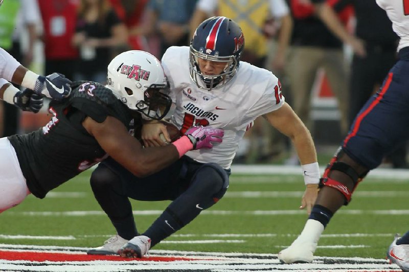 Arkansas State defensive end Chris Odom (left) sacks South Alabama quarterback Cole Garvin during the Red Wolves’ 17-7 victory. Odom finished with three sacks for ASU, which has won two games in a row after starting the season 0-4.