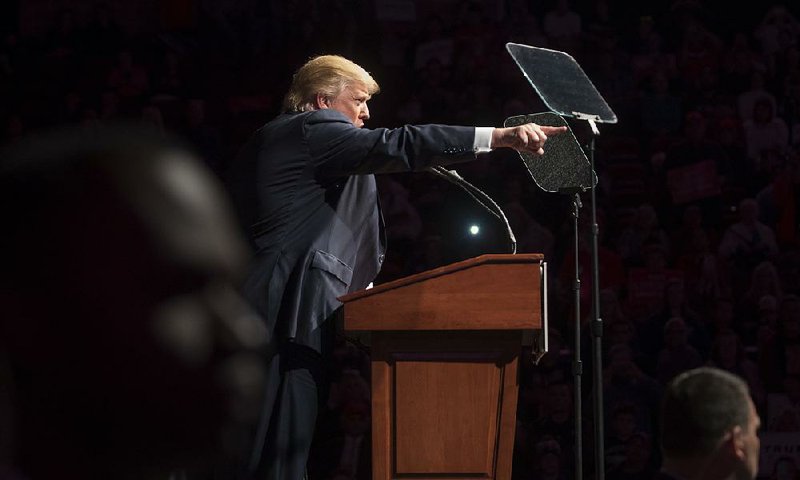 Donald Trump delivers a speech Saturday at a rally in Bangor, Maine. On Twitter, Trump repeated his assertion that Hillary Clinton should be in jail instead of running in “what looks like a rigged election.” 