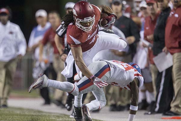 Arkansas receiver Keon Hatcher jumps over an Ole Miss defender during a game Saturday, Oct. 15, 2016, in Fayetteville. 