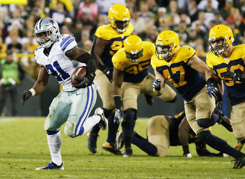 Dallas running back Ezekiel Elliott (left) leaves several Green Bay defenders behind late in the second half Sunday at Lambeau Field in Green Bay, Wis. Elliott ran for 157 yards as the Cowboys never trailed in knocking off the Packers 30-16.