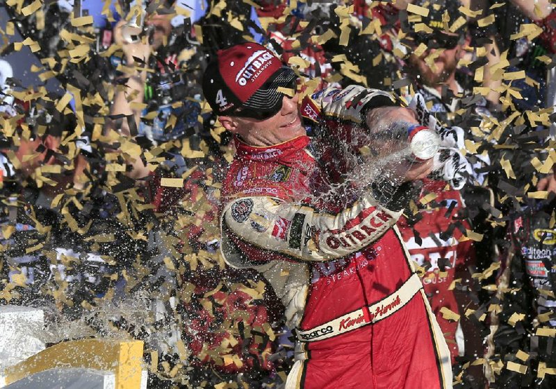 NASCAR driver Kevin Harvick celebrates in victory lane after winning the Hollywood Casino 400 at Kansas Speedway in Kansas City, Kan. The victory was Harvick’s fourth of the year and advances him to the next stage of the Chase for the NASCAR Sprint Cup Championship. The series heads to Talladega, Ala. on Sunday