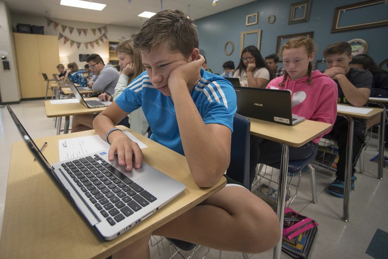 Stan Sorkov uses his Chromebook during eighth-grade English on Tuesday at Kirksey Middle School in Rogers.