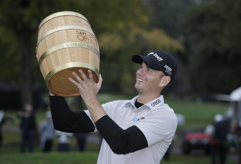 Brendan Steele lifts up his trophy on the 18th green of the Silverado Resort North Course after winning the Safeway Open PGA golf tournament, Sunday, Oct. 16, 2016, in Napa, Calif. 